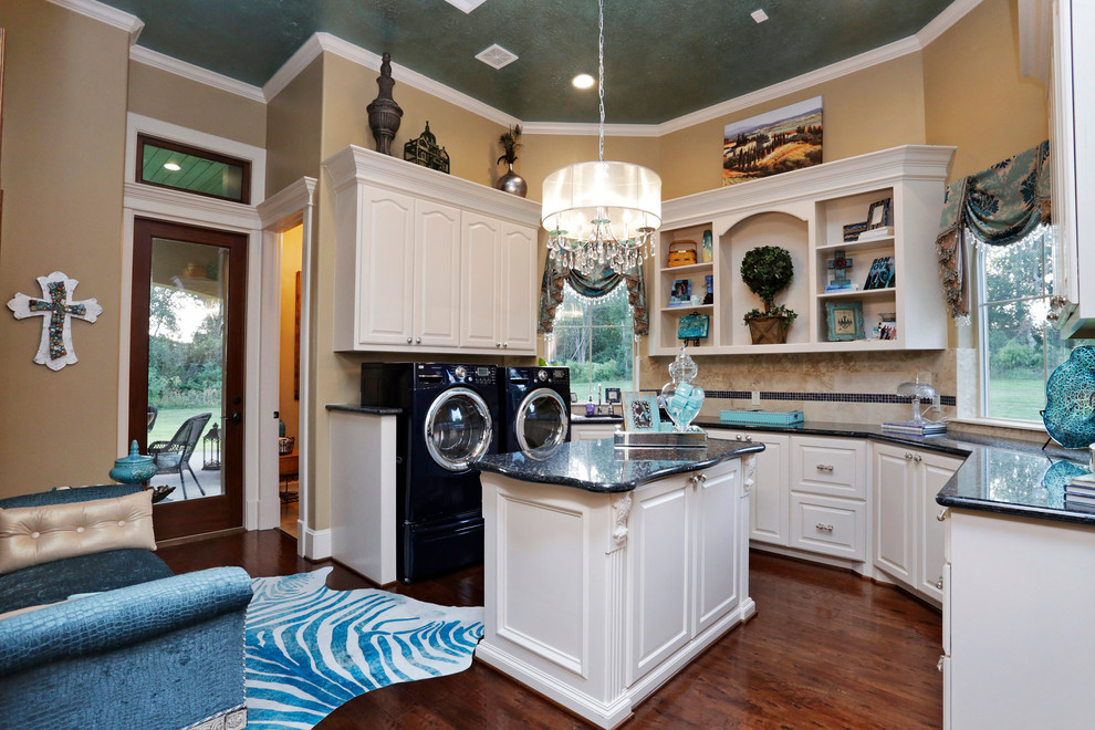 Traditional u-shaped dedicated laundry room in Houston with raised-panel cabinets, white cabinets, a side-by-side washer and dryer, granite benchtops and medium hardwood floors.