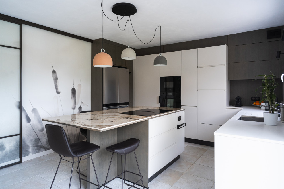This is an example of a mid-sized contemporary l-shaped separate kitchen in Angers with an integrated sink, beaded inset cabinets, beige cabinets, quartz benchtops, beige splashback, engineered quartz splashback, black appliances, ceramic floors, with island, beige floor, multi-coloured benchtop and wallpaper.