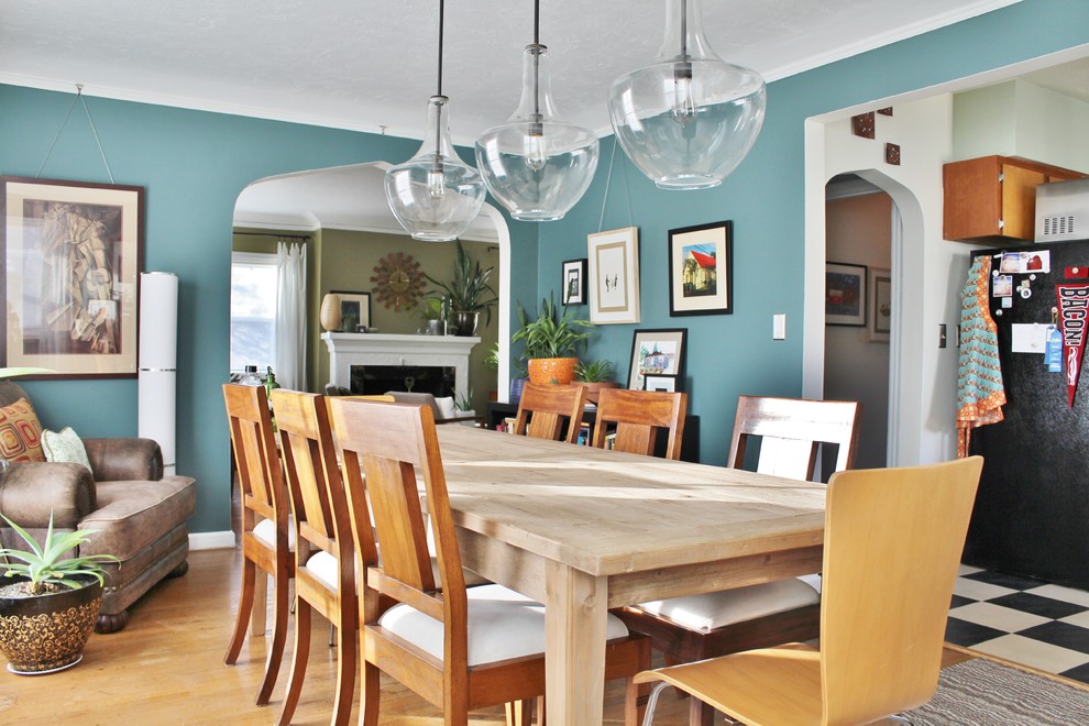 Photo of an eclectic dining room in Portland with blue walls.