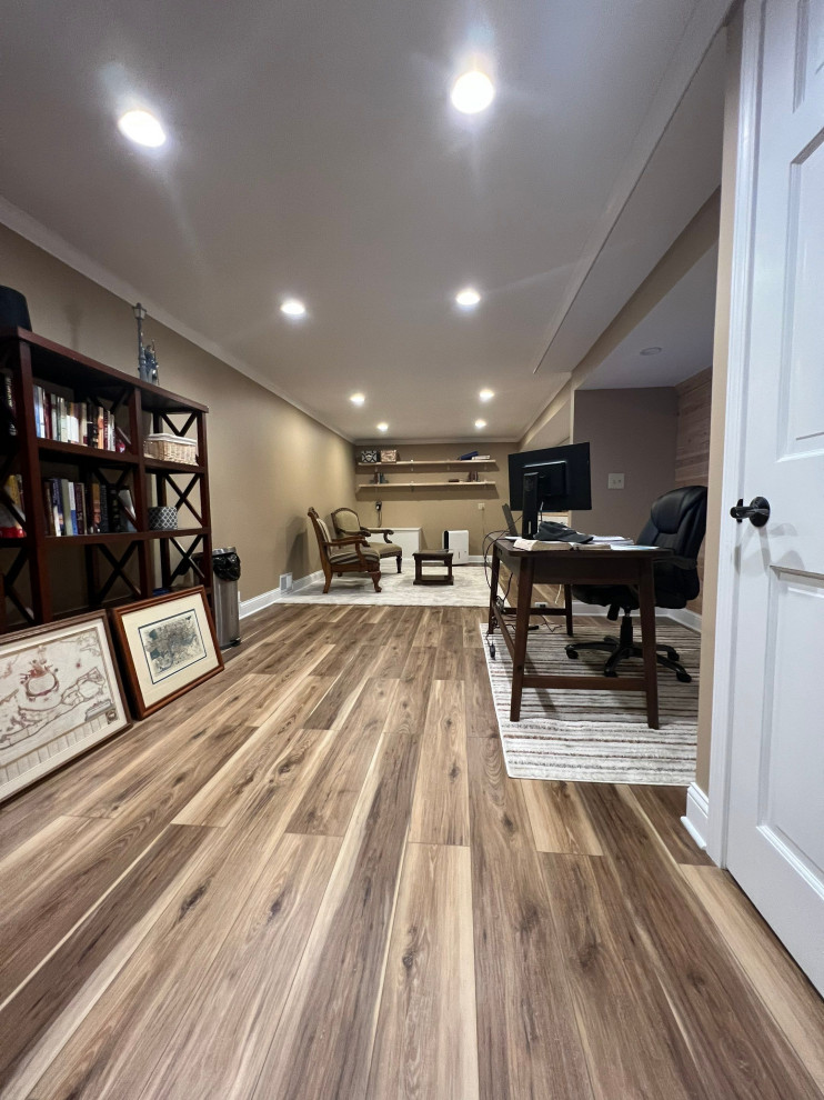Inspiration for a country basement in Chicago with beige walls, vinyl floors and brown floor.