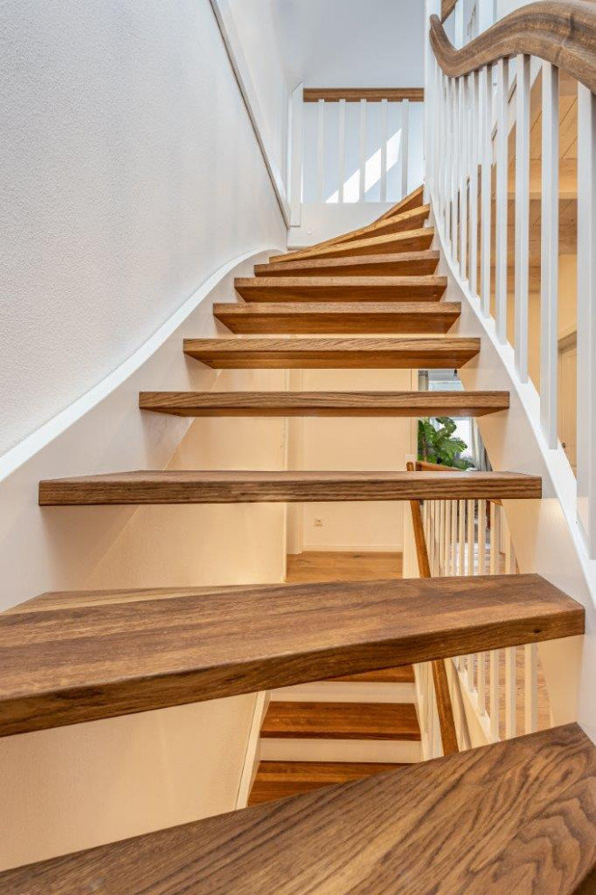 Rural wood wood railing staircase in Nuremberg with open risers.