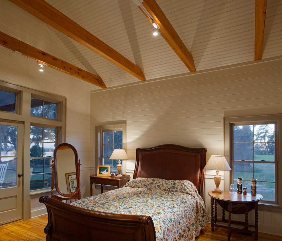 Photo of a large country master bedroom in Charleston with white walls and light hardwood floors.