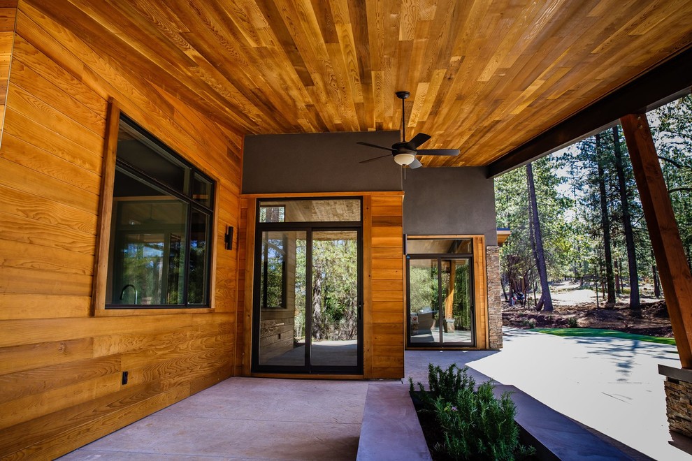 Photo of a mid-sized contemporary one-storey brown house exterior in Sacramento with mixed siding and a flat roof.