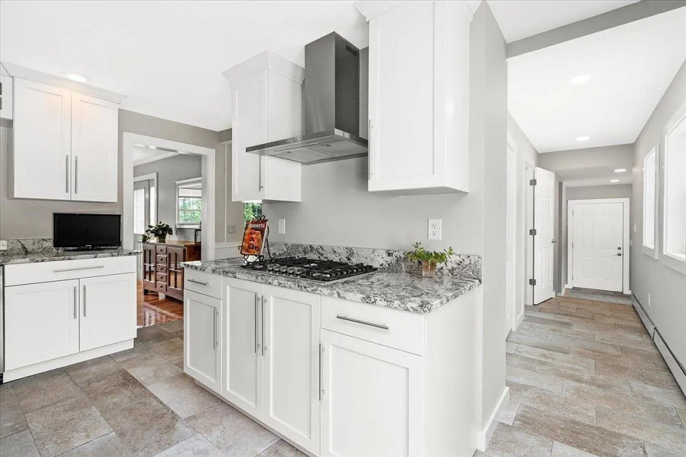 Example of a large transitional u-shaped enclosed kitchen design in Boston with shaker cabinets, white cabinets, granite countertops, stainless steel appliances, an island and gray countertops