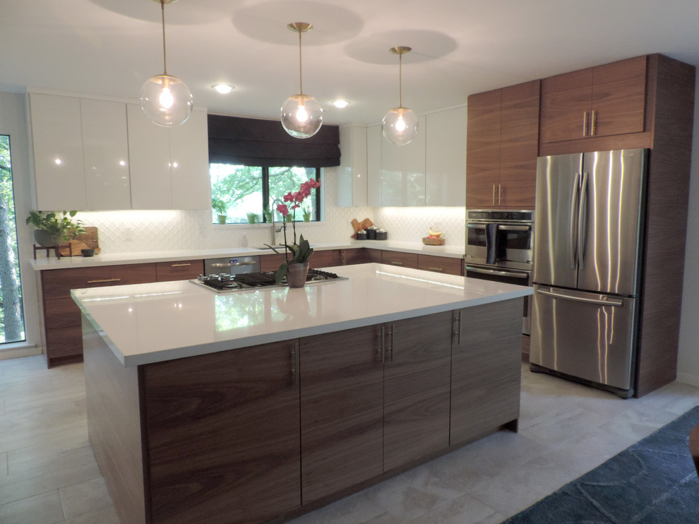 Large midcentury l-shaped open plan kitchen in Dallas with an undermount sink, flat-panel cabinets, white cabinets, quartz benchtops, white splashback, ceramic splashback, stainless steel appliances, ceramic floors, with island and grey floor.
