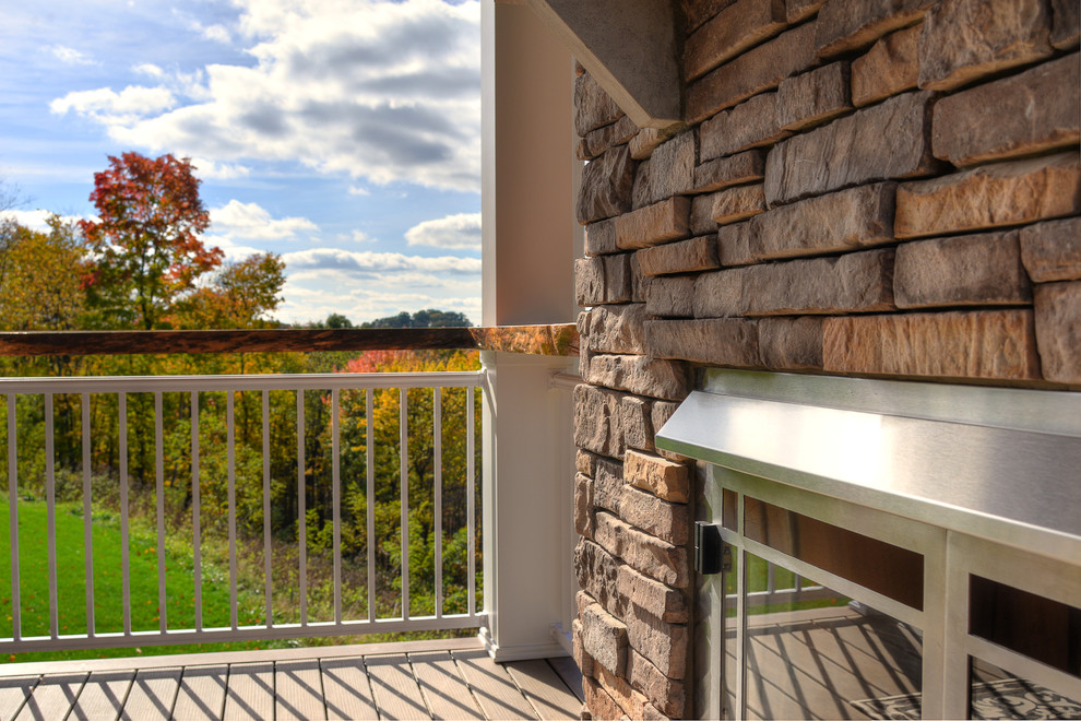 Mid-sized mountain style backyard deck photo with a fire pit and a roof extension