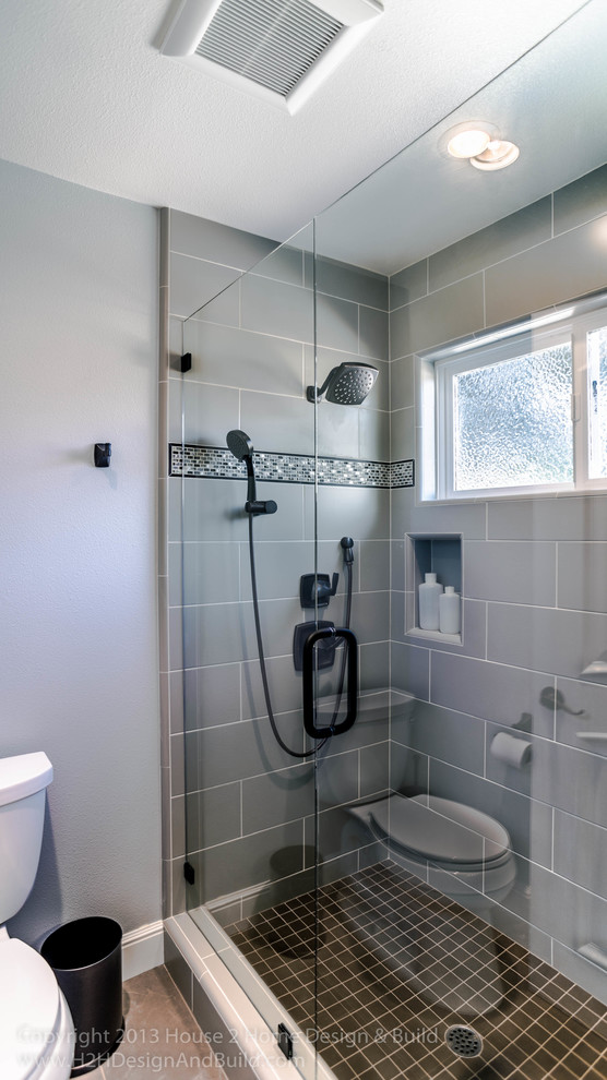 Photo of a mid-sized transitional bathroom in San Francisco with an undermount sink, recessed-panel cabinets, grey cabinets, engineered quartz benchtops, an alcove shower, a two-piece toilet, gray tile, ceramic tile, grey walls and porcelain floors.