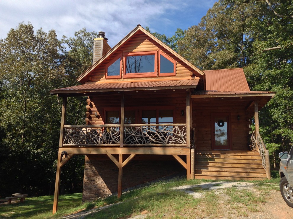 Photo of a mid-sized country two-storey exterior in Atlanta with wood siding.