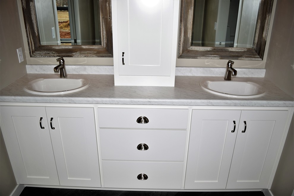 Inspiration for a mid-sized master ceramic tile bathroom remodel with recessed-panel cabinets, white cabinets, a two-piece toilet, beige walls, a drop-in sink and laminate countertops
