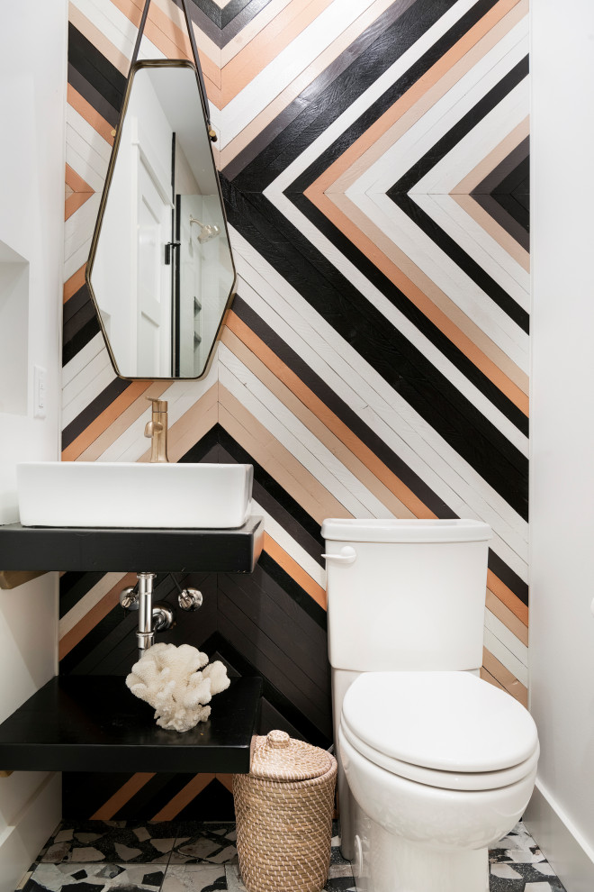 Contemporary powder room in Minneapolis with open cabinets, black cabinets, a two-piece toilet, white walls, terrazzo floors, a vessel sink, multi-coloured floor and black benchtops.