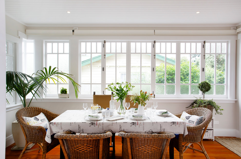 This is an example of a mid-sized traditional open plan dining in Auckland with medium hardwood floors, no fireplace and beige walls.