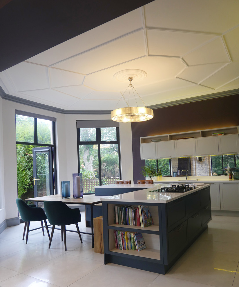 This is an example of a large contemporary eat-in kitchen in Other with an integrated sink, shaker cabinets, blue cabinets, quartzite benchtops, multi-coloured splashback, mirror splashback, panelled appliances, ceramic floors, with island, white floor and white benchtop.