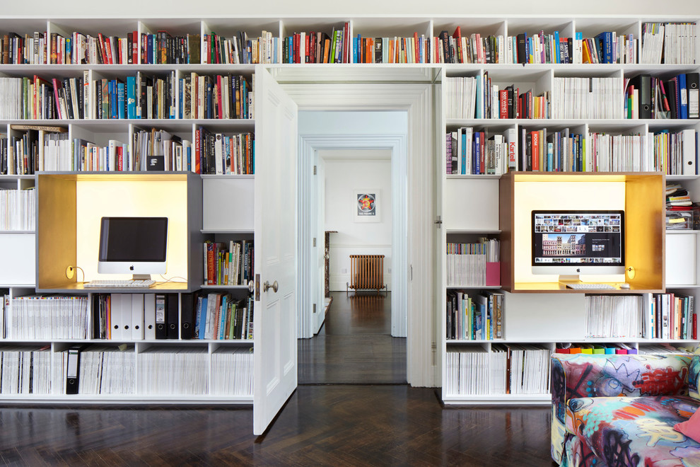 Inspiration for a large contemporary study room in London with white walls, dark hardwood floors and a built-in desk.