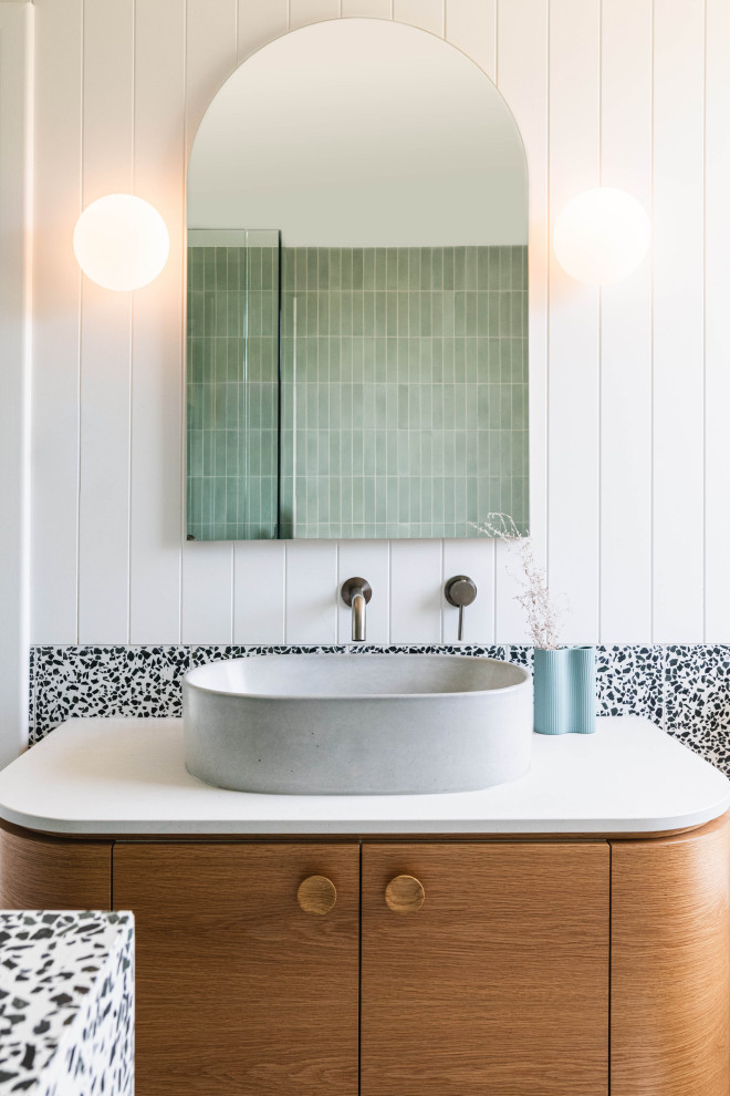 Contemporary bathroom in Adelaide with flat-panel cabinets, medium wood cabinets, black and white tile, white walls, a vessel sink, white benchtops and a single vanity.