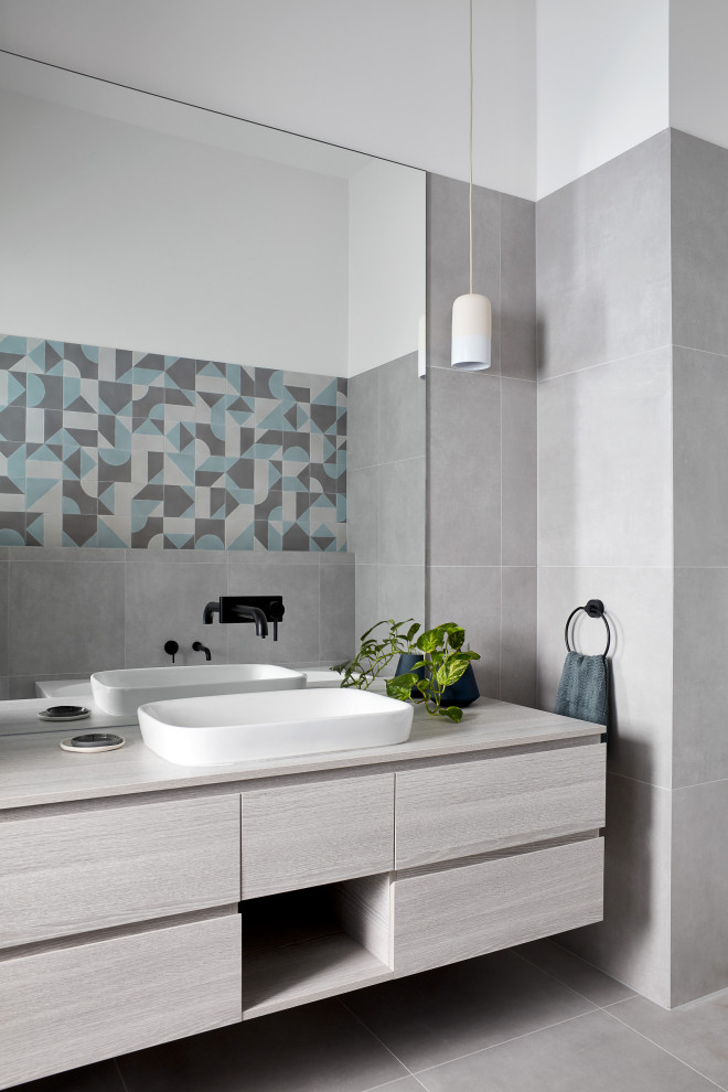 Design ideas for a contemporary bathroom in Melbourne with flat-panel cabinets, grey cabinets, gray tile, white walls, a vessel sink, grey floor, grey benchtops, a single vanity and a floating vanity.