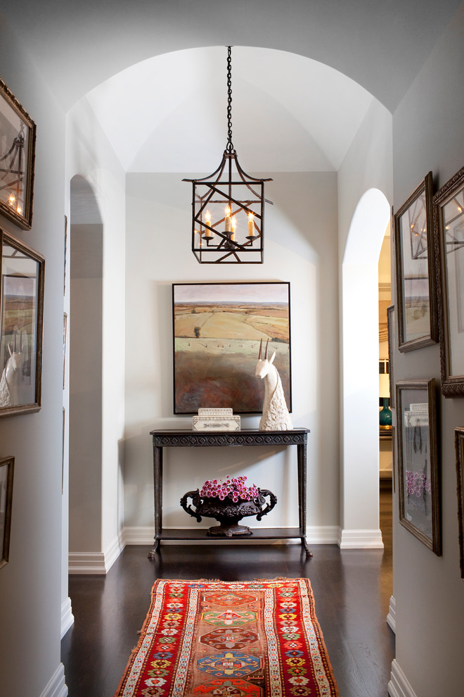 Photo of a transitional hallway in Los Angeles with dark hardwood floors and white walls.