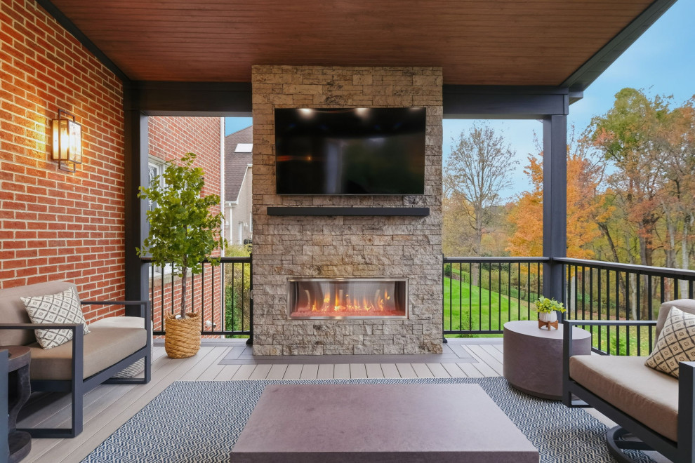 Example of a mid-sized transitional backyard second story mixed material railing deck design with a fireplace and a roof extension