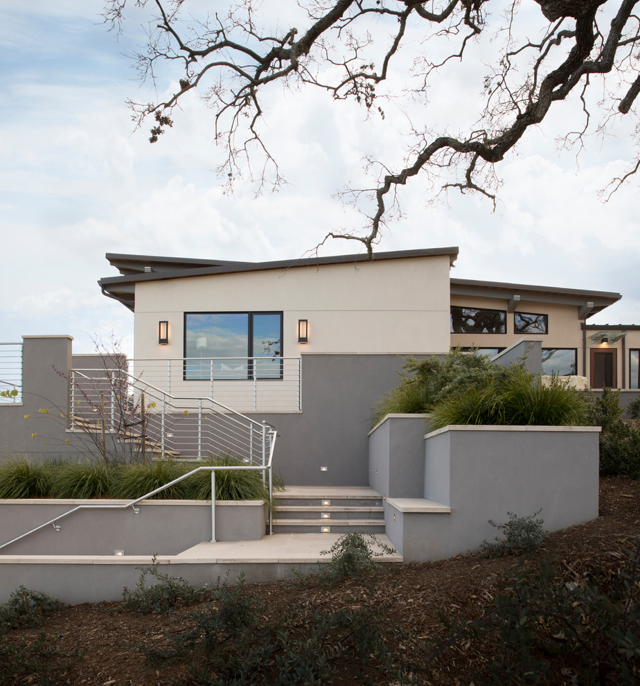 Design ideas for an expansive modern two-storey stucco grey house exterior in San Francisco with a metal roof.