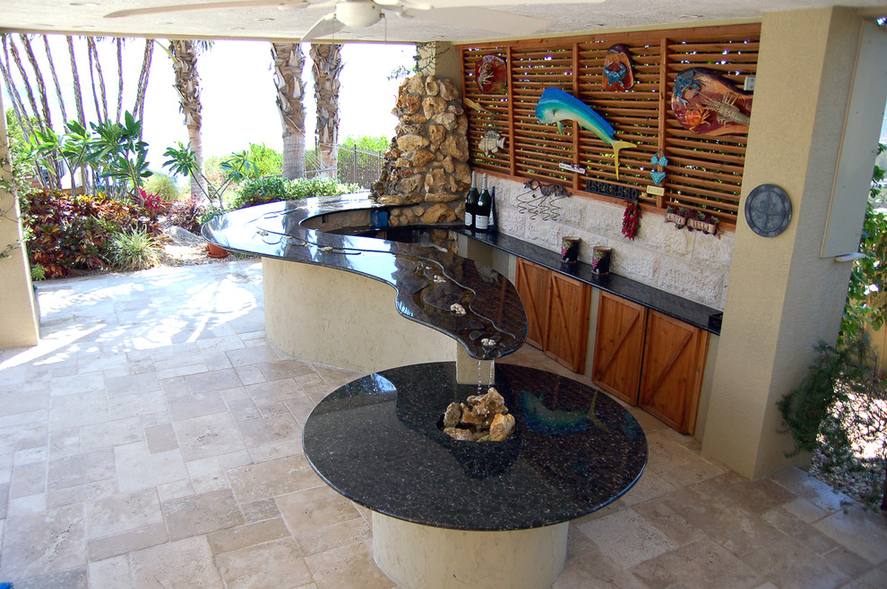 Photo of a mid-sized mediterranean side yard patio in Tampa with a water feature, tile and a roof extension.