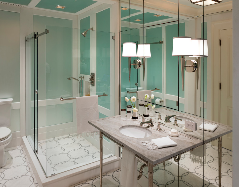 Photo of a transitional kids bathroom in New York with recessed-panel cabinets, white cabinets, an open shower, multi-coloured tile, beige walls, marble floors, an undermount sink and marble benchtops.