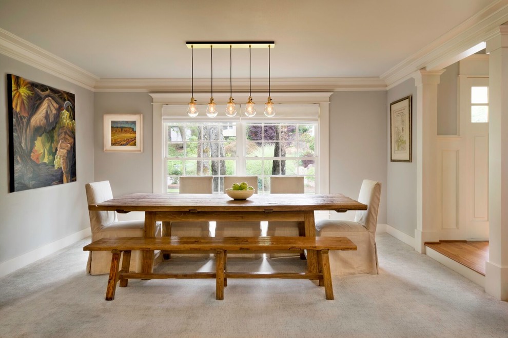 This is an example of a transitional kitchen/dining combo in Portland with grey walls, carpet and no fireplace.