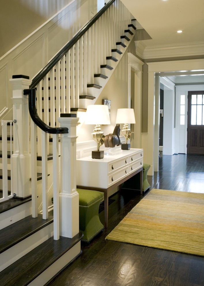 Design ideas for a traditional entryway in Atlanta with beige walls, dark hardwood floors and black floor.