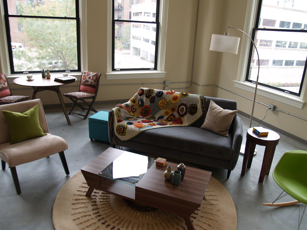 Design ideas for an eclectic living room in St Louis with beige walls and concrete floors.