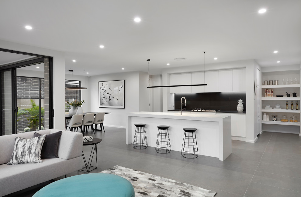 Inspiration for a large contemporary eat-in kitchen in Sydney with black splashback, stainless steel appliances, with island and white benchtop.