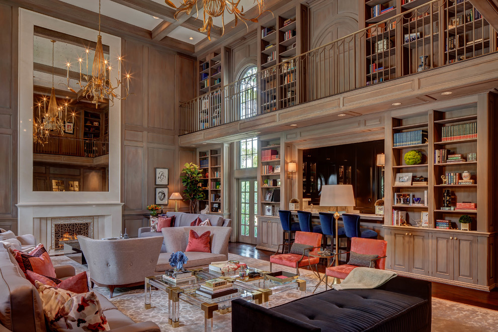 This is an example of an expansive transitional loft-style family room in Houston with a library, brown walls, dark hardwood floors, a standard fireplace and brown floor.