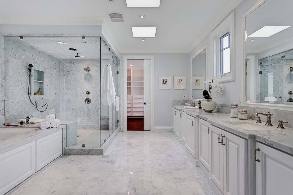 Photo of a large transitional master bathroom in Brisbane with an undermount sink, raised-panel cabinets, white cabinets, marble benchtops, a drop-in tub, a corner shower, gray tile, stone slab, grey walls and marble floors.