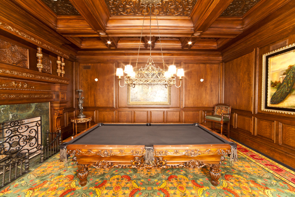 This is an example of a large traditional enclosed family room in New York with a game room, brown walls, carpet, a standard fireplace, a stone fireplace surround, no tv and multi-coloured floor.