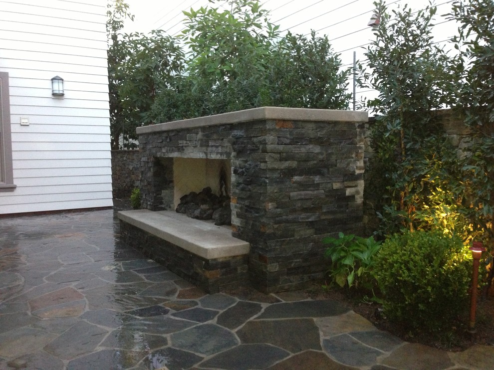 Patio - mid-sized transitional courtyard stamped concrete patio idea in Orange County with a fire pit and no cover