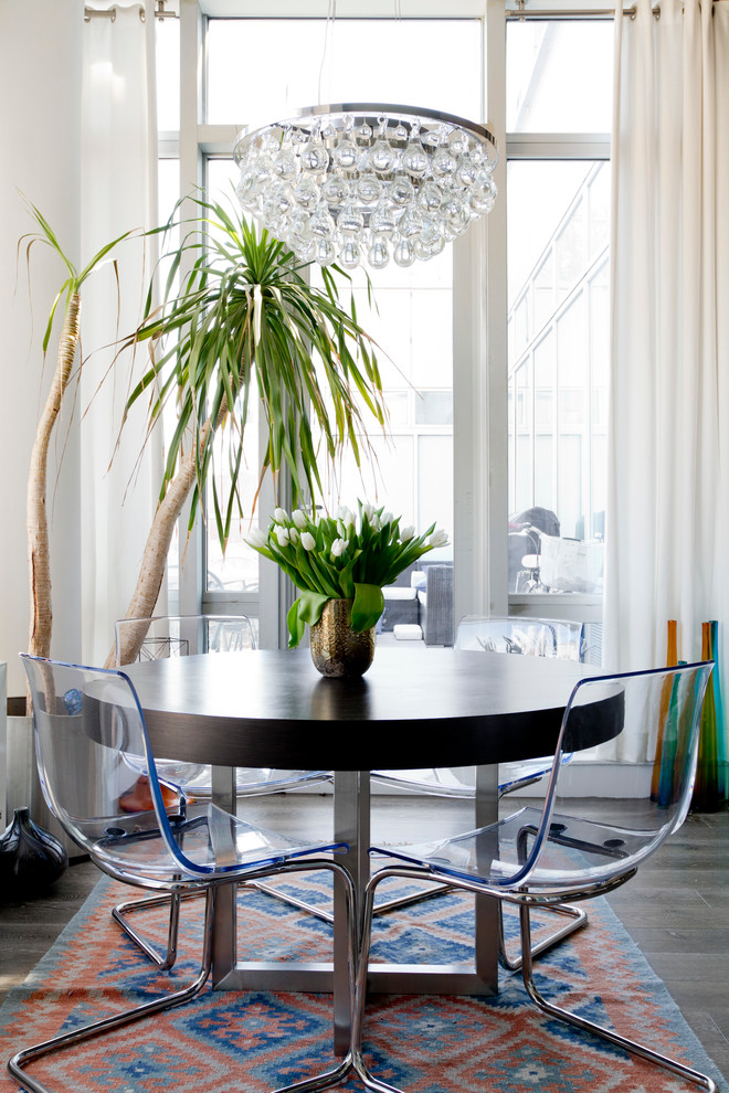 Photo of an eclectic dining room in New York with white walls and dark hardwood floors.