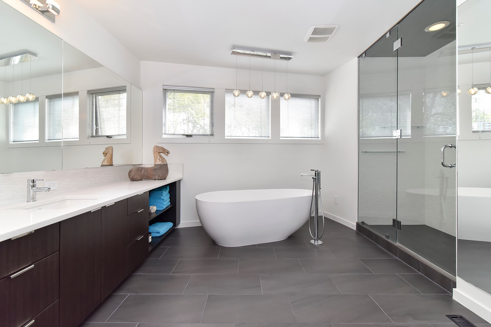 Inspiration for a contemporary freestanding bathtub remodel in Calgary with an undermount sink, flat-panel cabinets, dark wood cabinets and white walls