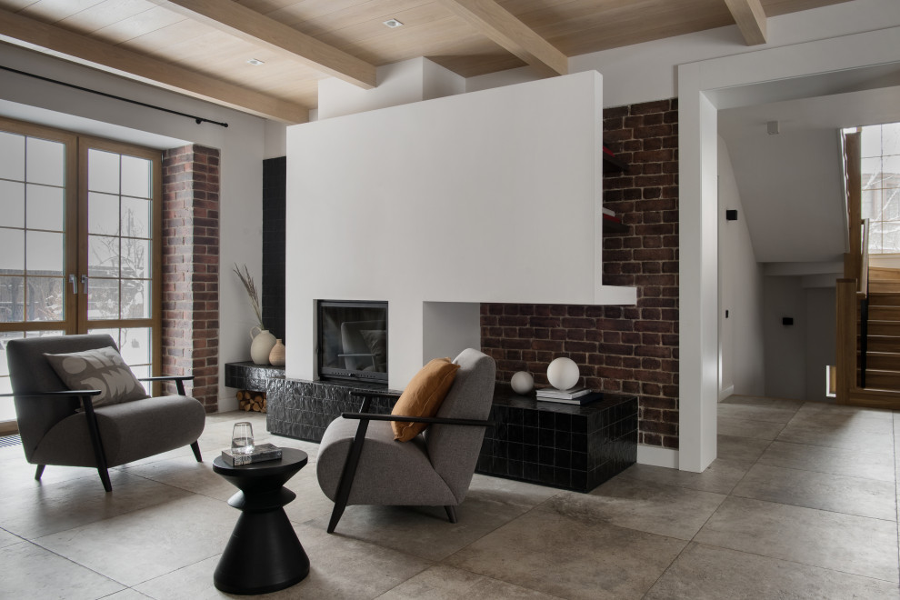 Inspiration for a mid-sized contemporary living room in Moscow with a library, white walls, porcelain floors, a standard fireplace, a tile fireplace surround, grey floor, exposed beam and brick walls.