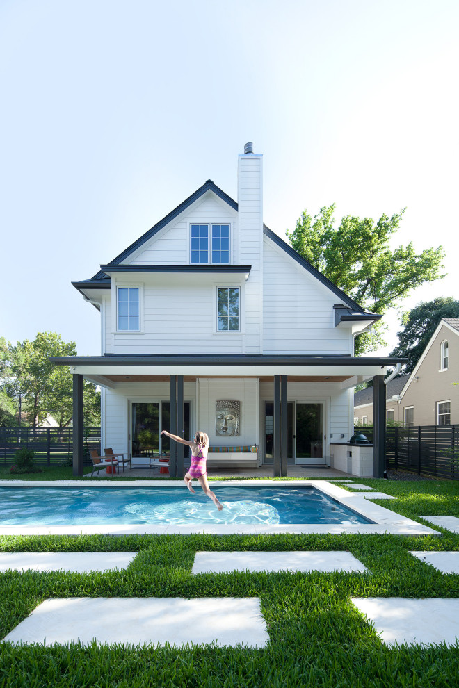 Transitional pool photo in Austin with a bbq area