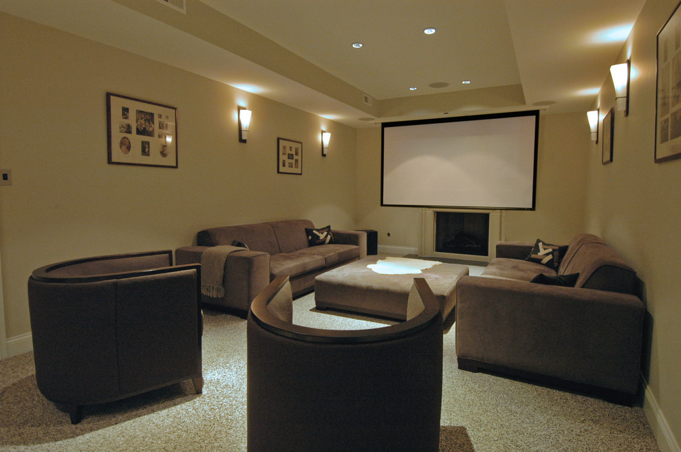 Large traditional enclosed home theatre in Chicago with beige walls, carpet and a projector screen.
