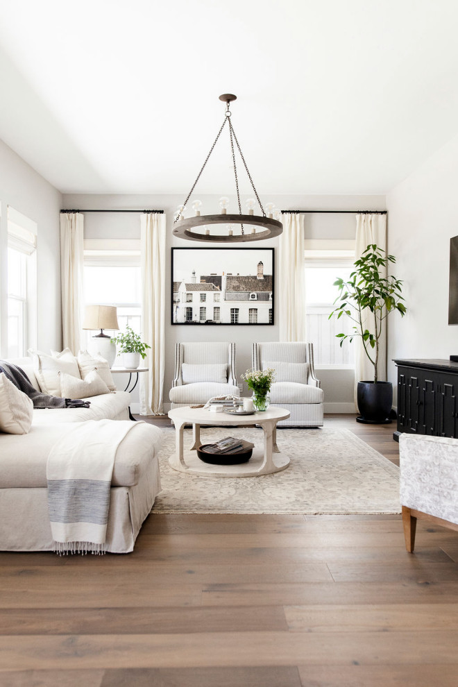 Transitional open concept living room in Sacramento with grey walls, medium hardwood floors, a wall-mounted tv and brown floor.