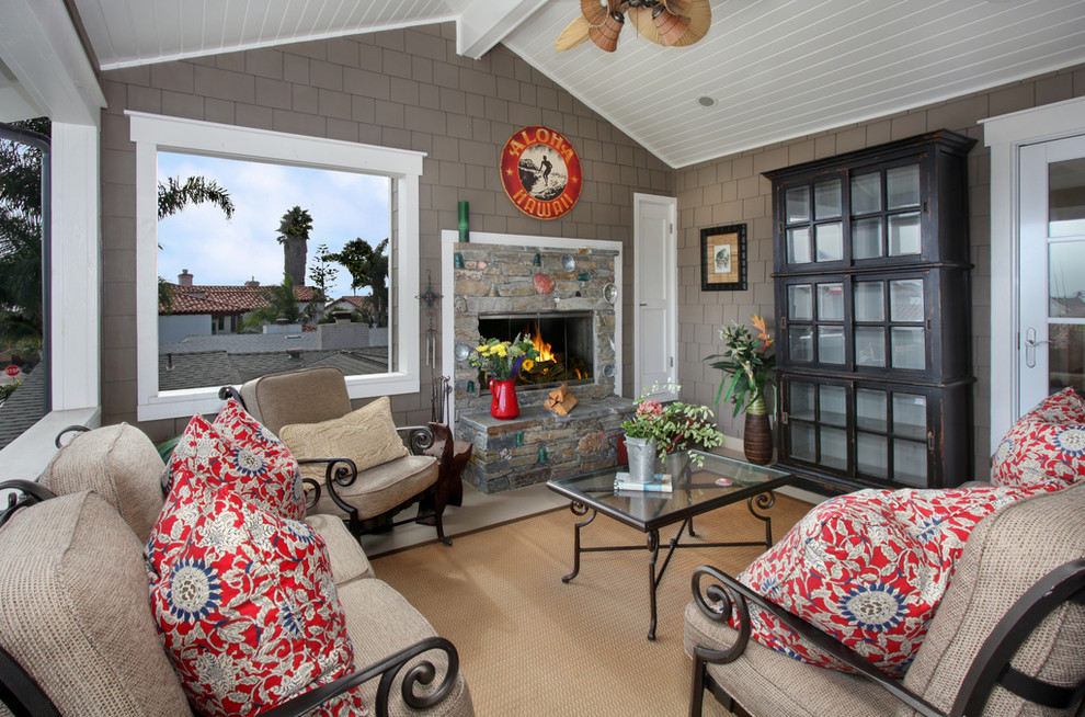 Design ideas for a beach style verandah in Orange County with a fire feature.