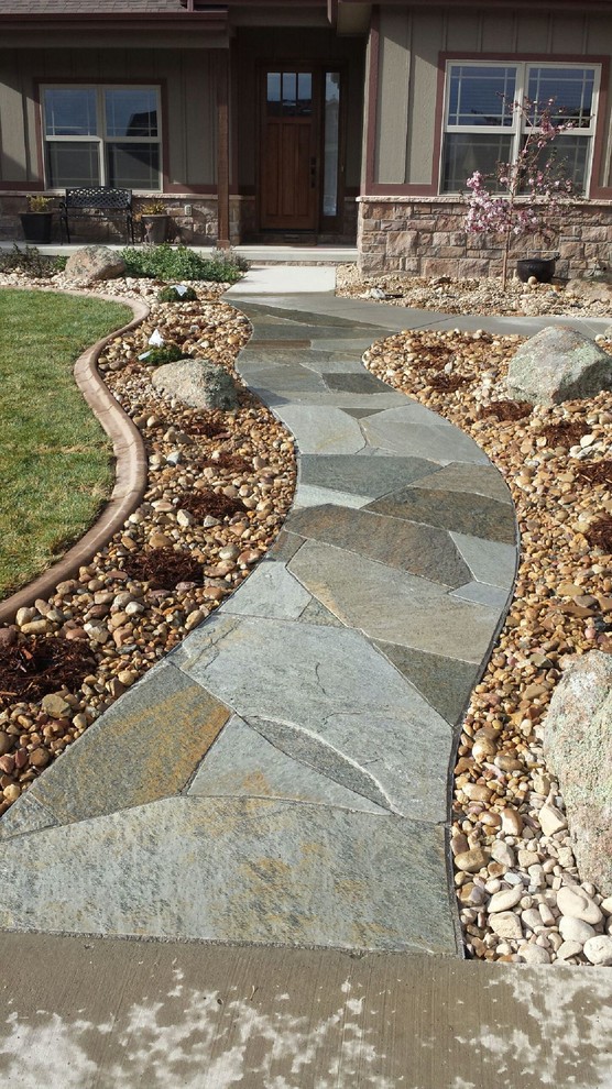 Inspiration for an arts and crafts front yard full sun garden in Denver with a garden path and natural stone pavers.