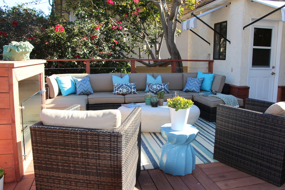 Photo of a mid-sized beach style backyard patio in Los Angeles with a fire feature and decking.
