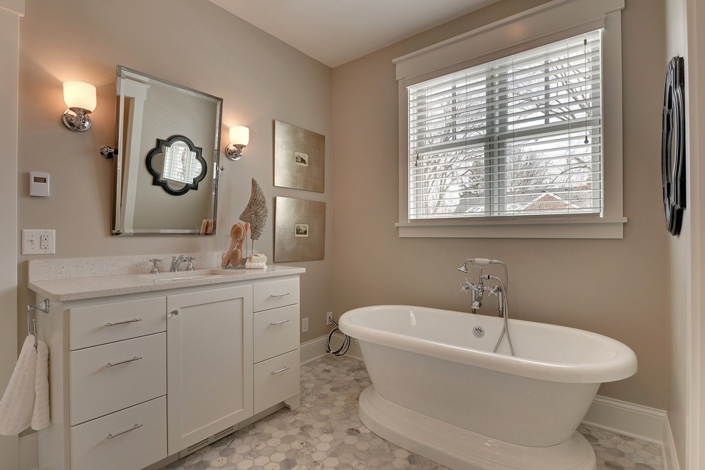 Photo of a traditional bathroom in Minneapolis with an undermount sink, shaker cabinets, white cabinets, a freestanding tub and white tile.