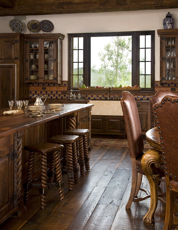 Inspiration for a large rustic medium tone wood floor eat-in kitchen remodel with a farmhouse sink, raised-panel cabinets, wood countertops, mosaic tile backsplash and an island