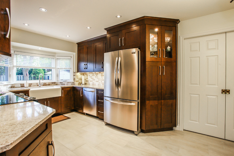 Example of a mid-sized transitional u-shaped porcelain tile enclosed kitchen design in Toronto with a farmhouse sink, shaker cabinets, dark wood cabinets, quartz countertops, beige backsplash, stone tile backsplash, stainless steel appliances and no island