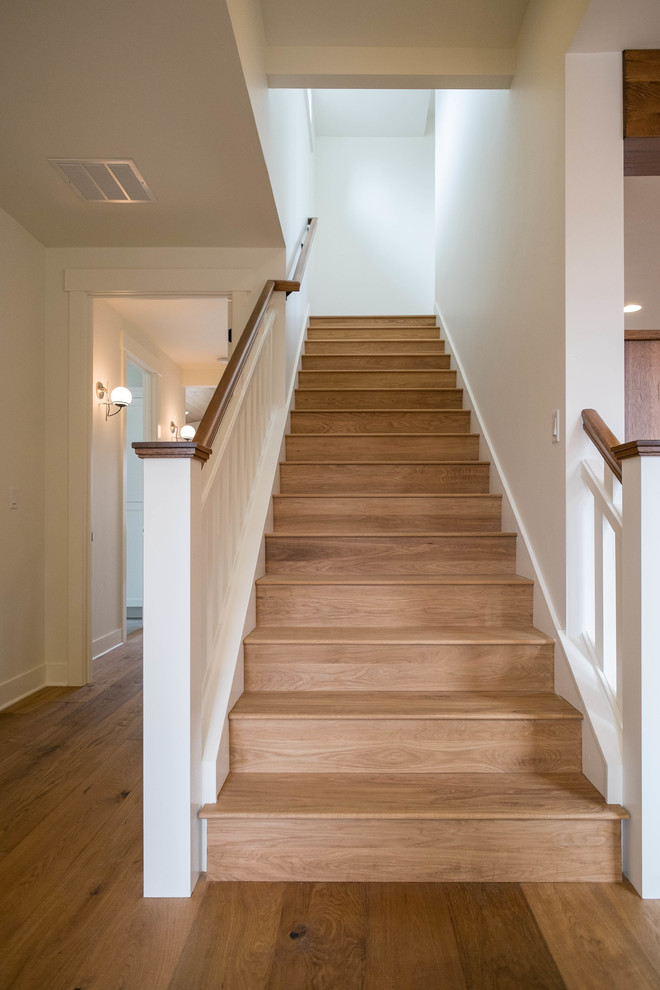 Inspiration for a mid-sized traditional wood straight staircase in Other with wood risers.