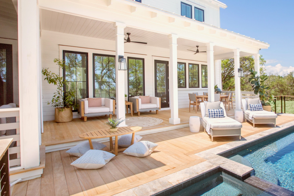 Inspiration for a beach style deck in Charleston with a roof extension and mixed railing.