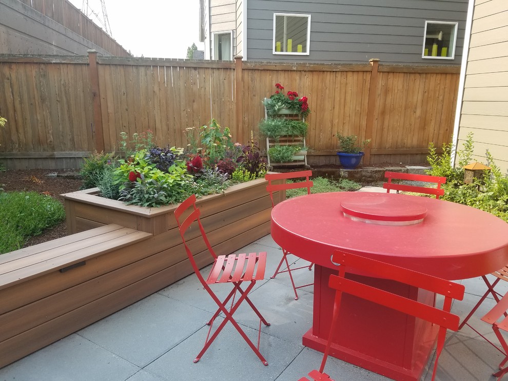 This is an example of a small backyard concrete paver landscaping in Seattle.