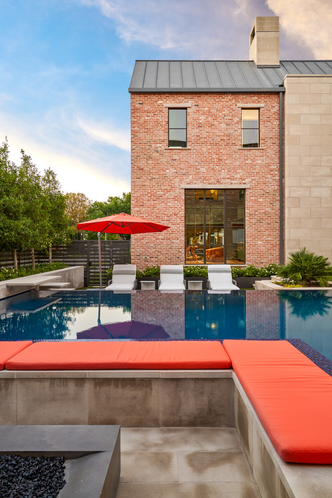 Beverly | 2018 - Mid-sized transitional backyard concrete and l-shaped infinity pool photo in Dallas