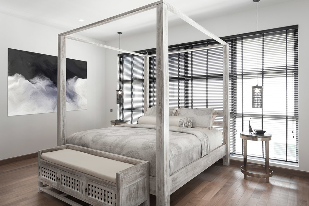Large contemporary master bedroom in Singapore with white walls and medium hardwood floors.
