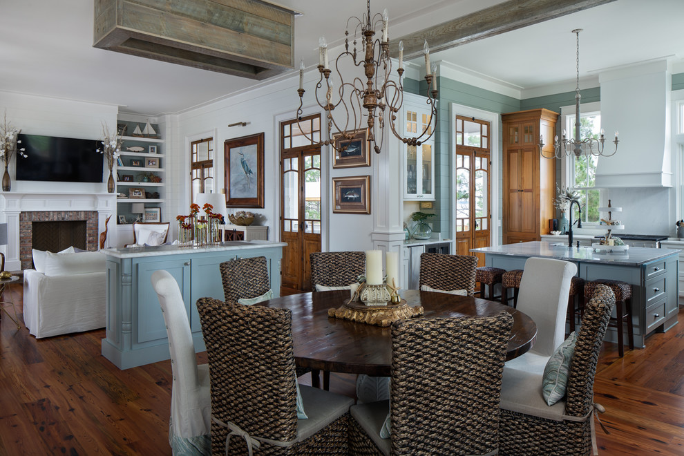 Beach style open plan dining in New Orleans with white walls, medium hardwood floors and brown floor.